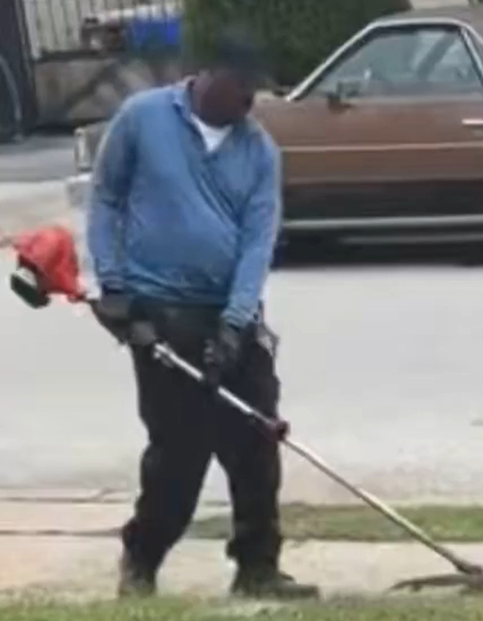Close-up of a neighbor trimming the lawn, sparking debate about neighborly entitlement Close-up of a neighbor trimming the lawn, sparking debate about neighborly entitlement
