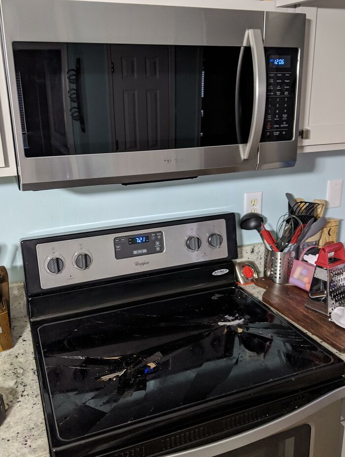 A shattered glass cooktop on a kitchen stove, showing a failed attempt to improve and renovate their homes