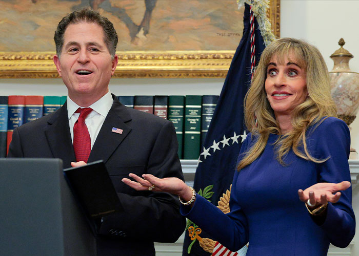 Dell CEO Michael Dell standing alongside his wife Susan Dell as they present to an audience.