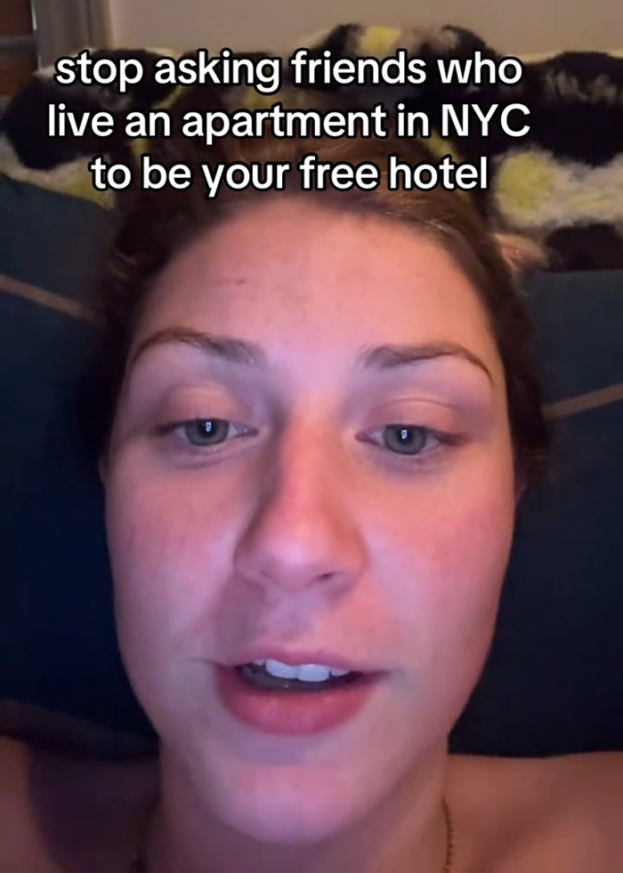 A woman speaking into a camera about NYC hotels and hosting friends in her apartment. A woman speaking into a camera about NYC hotels and hosting friends in her apartment.