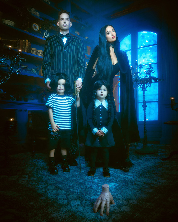 A family dressed in spooky Addams Family attire showcasing top celebrity Halloween costumes.