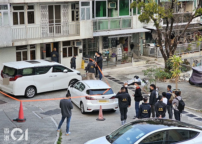Police investigating crime scene with cars and cordoned area Police investigating crime scene with cars and cordoned area