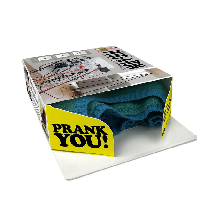 Open fake gift box revealing a real present inside with a Prank You message Open fake gift box revealing a real present inside with a Prank You message
