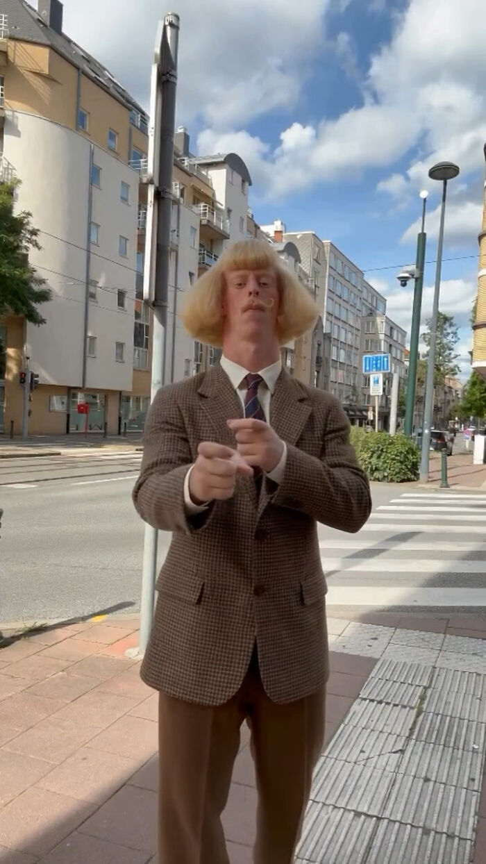 AI-generated blonde male character standing in a brown suit on a city street, raising concerns of deepfakes AI-generated blonde male character standing in a brown suit on a city street, raising concerns of deepfakes