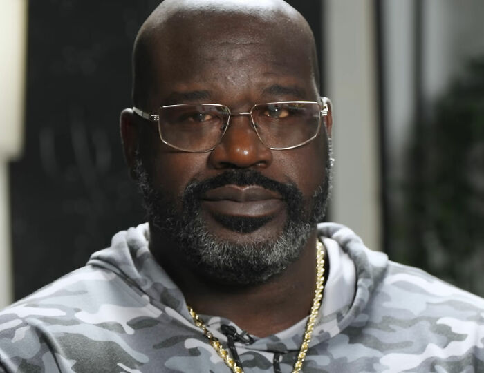 Close-up of Shaquille O'Neal wearing glasses and a camo hoodie Close-up of Shaquille O'Neal wearing glasses and a camo hoodie