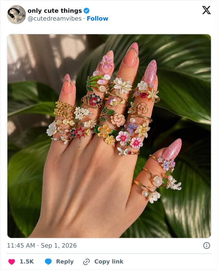 Hand with multiple colorful flower rings showcasing cute jewelry