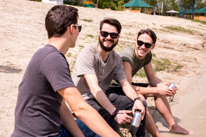Three men sitting on a sandy beach holding cans, discussing a potential Australia Trip instead of a SIL's Wedding. Three men sitting on a sandy beach holding cans, discussing a potential Australia Trip instead of a SIL's Wedding.