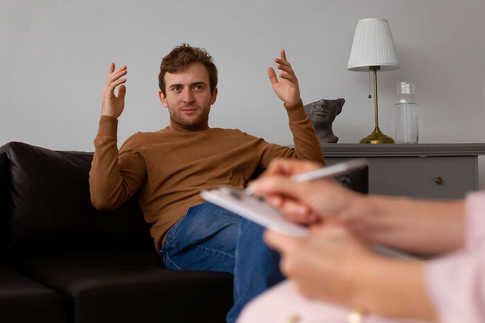 A man speaking to a therapist during a counseling session related to difficult divorce stories