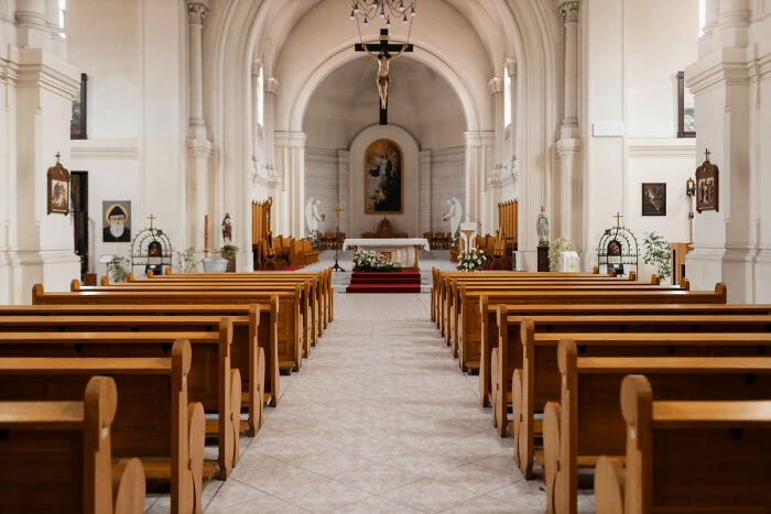 The interior of an empty church sanctuary representing religious themes tied to lesser-known cults.