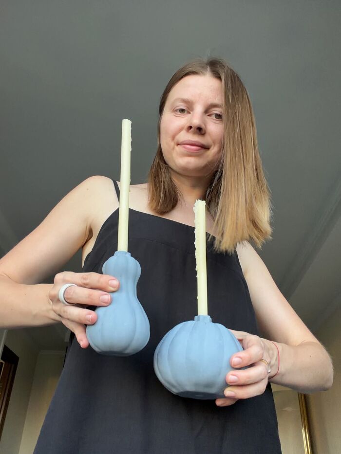 Woman holding blue pumpkin candle holders made from 3D prints