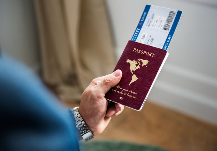Hand holding passport and ticket for travel as part of getting back at ex