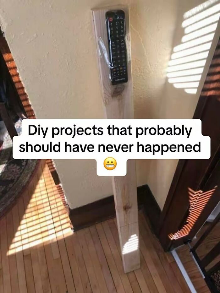 TV remote taped to a large wooden post, highlighting a DIY home improvement fiasco.