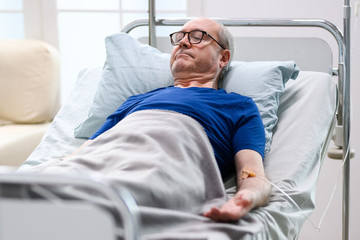 An elderly patient in a hospital bed, illustrative of the cases healthcare workers treat.
