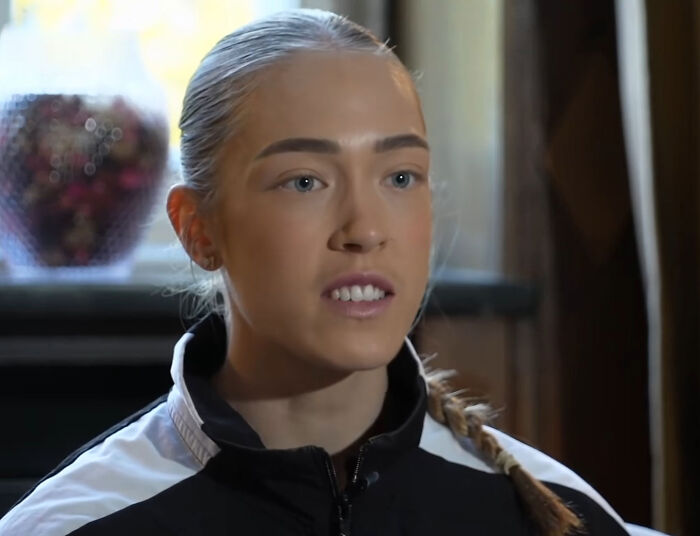 Close-up headshot of a HYROX athlete with blonde slicked-back hair looking straight ahead during an interview.