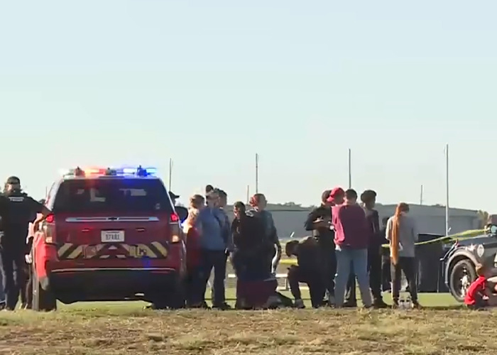 Police and crowd at youth soccer game incident scene Police and crowd at youth soccer game incident scene