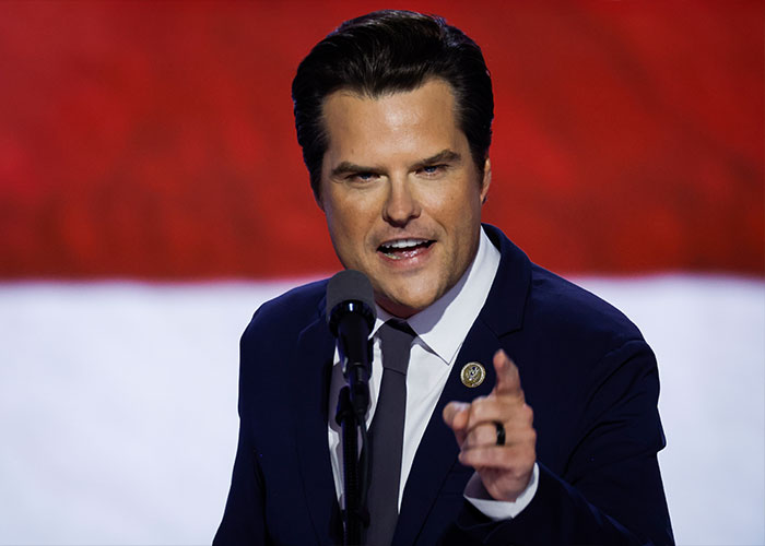 Matt Gaetz speaking at a microphone amidst public commentary on MAGA face aesthetics. Matt Gaetz speaking at a microphone amidst public commentary on MAGA face aesthetics.