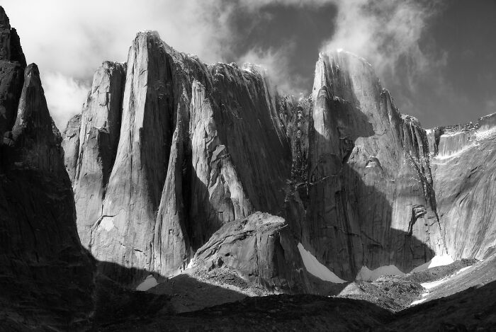 Dramatic black and white landscape photography of sheer mountain cliffs and rock faces