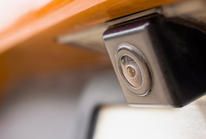 Close-up view of a small security camera lens used to gather evidence of a secret affair. Close-up view of a small security camera lens used to gather evidence of a secret affair.