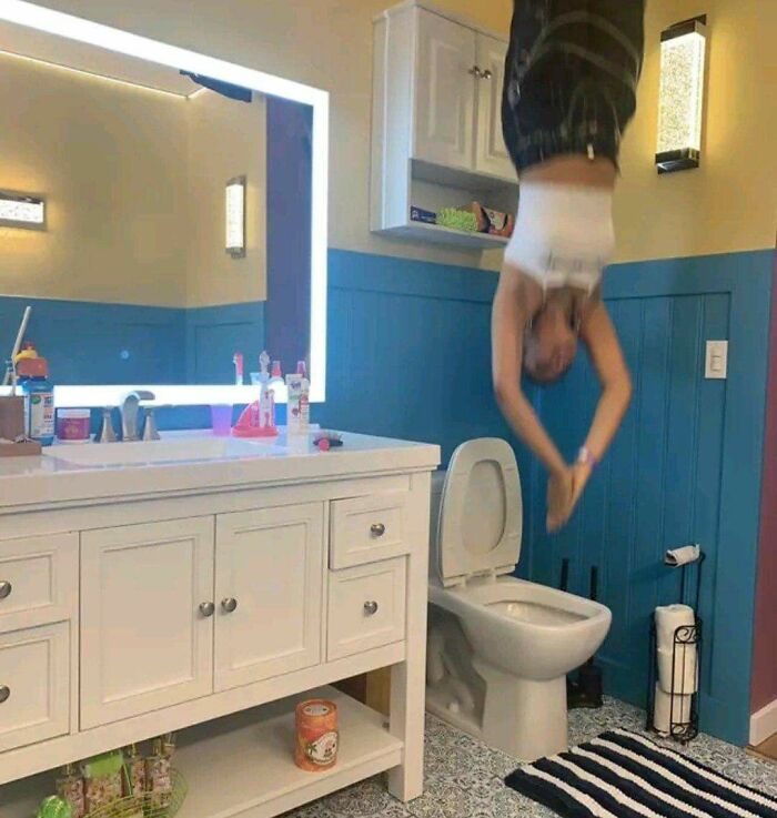 Cursed image of person diving upside down into toilet in bathroom