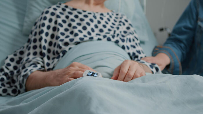 A patient resting in a hospital bed, symbolizing hardship during painful divorce stories.