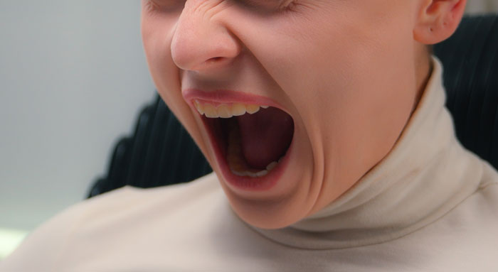 A woman screaming in anger, depicting a marriage-ending scandal. A woman screaming in anger, depicting a marriage-ending scandal.