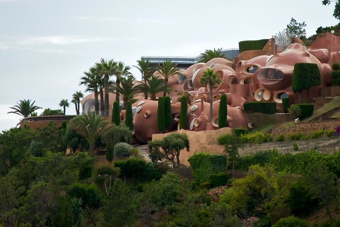 Unique strange building structures in lush greenery with round shapes and unusual design