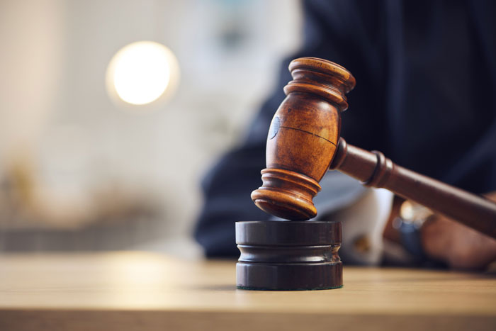 Close up of a wooden gavel representing a court ruling after a secret affair. Close up of a wooden gavel representing a court ruling after a secret affair.