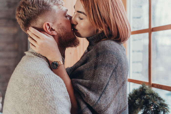 A young couple kissing intimately before experiencing real-life divorce stories.