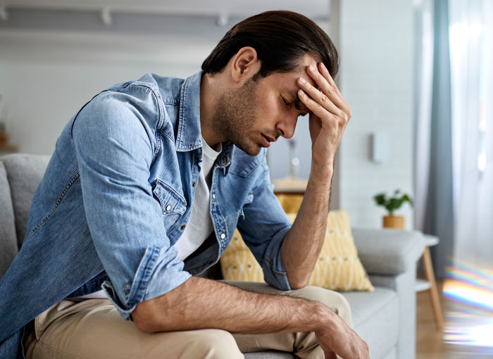 Stressed husband holding his head after discovering his wife’s pregnancy by another man and her secret affair. Stressed husband holding his head after discovering his wife’s pregnancy by another man and her secret affair.