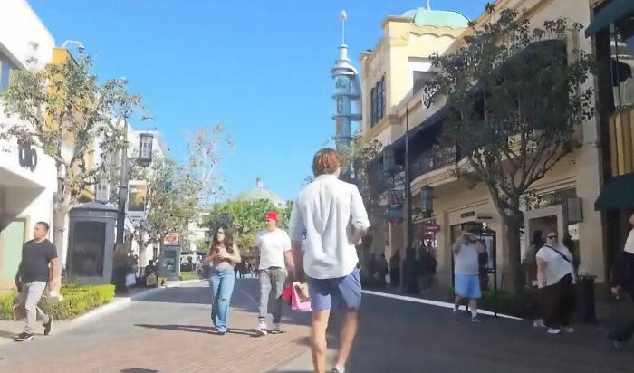 Manosphere adherent walks in an outdoor Los Angeles shopping mall