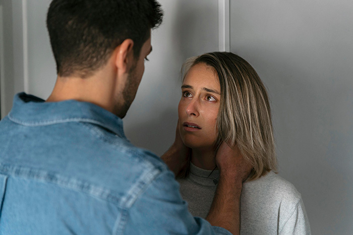 An anxious woman looking at a man after an unexpected turn during a girls trip.