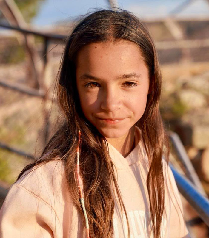 A portrait of Chad Lowe's daughter Fiona Lowe smiling gently in warm natural sunlight.