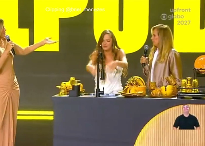 Stage scene from nepo baby reality show with three women and golden props Stage scene from nepo baby reality show with three women and golden props