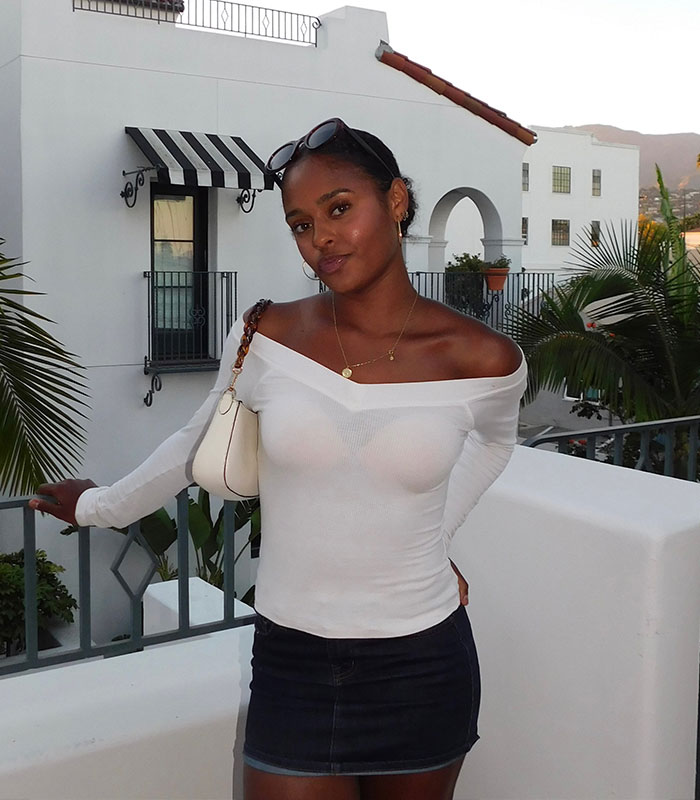 Young woman in white top at sorority scandal college event