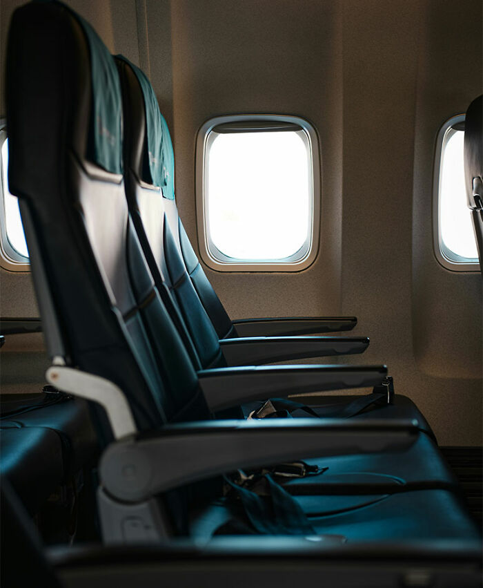 Empty airplane seats by the window inside cabin Empty airplane seats by the window inside cabin