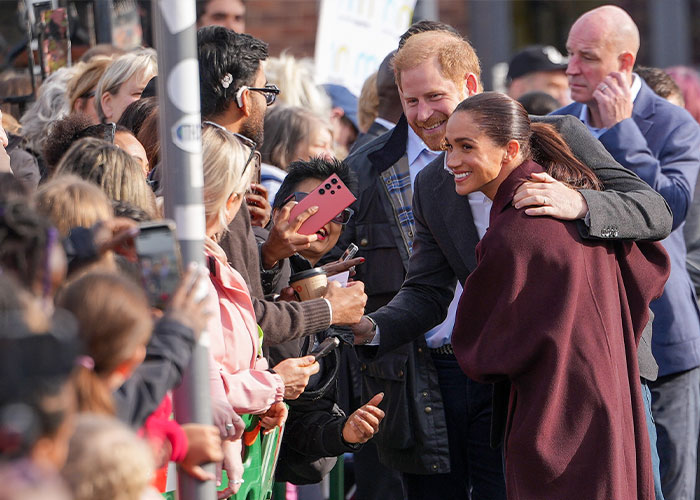 Meghan Markle interacting with members of the public during a food bank visit.