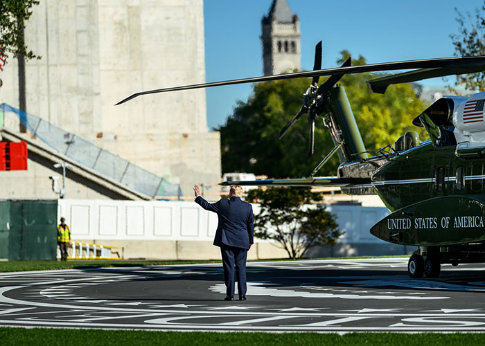 Wide view showing Trump waving at nobody on an empty helipad next to Marine One as cameraman zooms out. Wide view showing Trump waving at nobody on an empty helipad next to Marine One as cameraman zooms out.