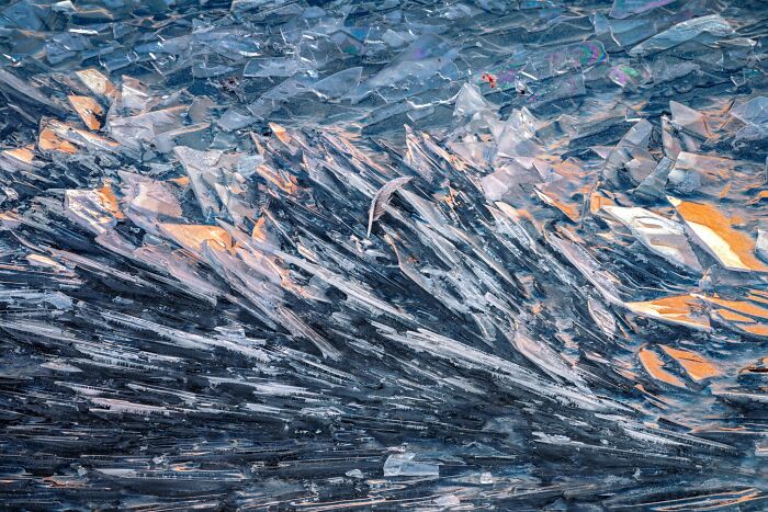Natural landscape photography of jagged ice sheets glistening in sunlight.