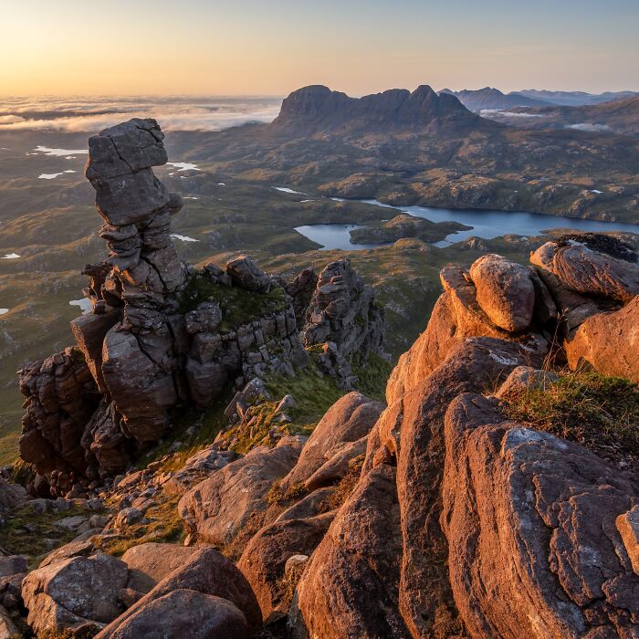 Rocky mountain outcrop overlooking lakes at sunset for Natural Landscape Photography Awards.