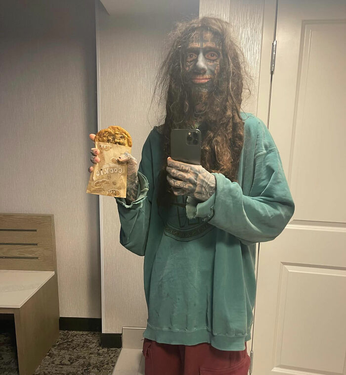 A selfie of the Florida Demonologist with full facial tattoos holding a cookie bag. A selfie of the Florida Demonologist with full facial tattoos holding a cookie bag.