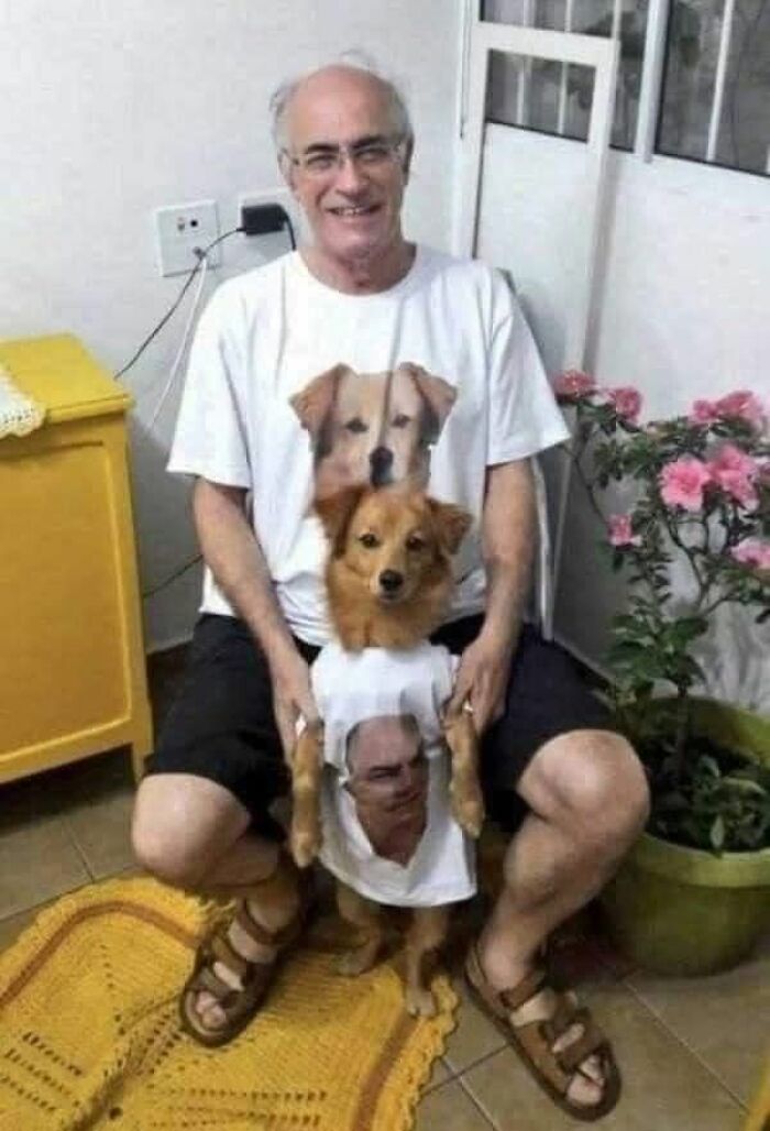 Funny animals, a smiling man and his dog wearing matching t-shirts with each other's faces printed on them
