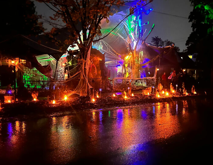 Epic Halloween display with colorful lights and spooky decorations near water Epic Halloween display with colorful lights and spooky decorations near water