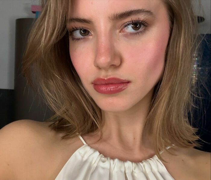 Model wearing elegant makeup highlighting fashion industry standards