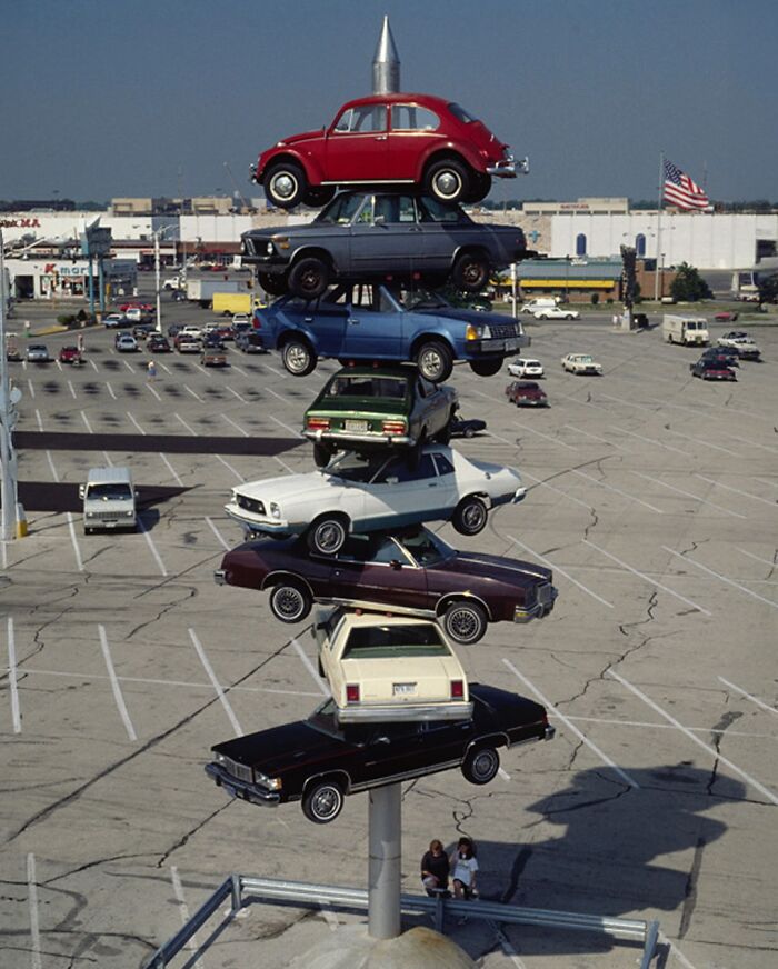 Spindle sculpture in Berwyn, Illinois, displaying a stack of real cars as an iconic piece of public art.