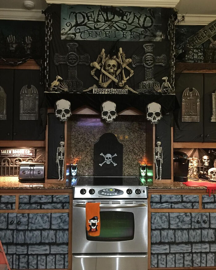 Kitchen decorated with skulls and gravestones for Halloween homes inspiration.