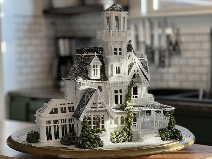 Intricate haunted victorian house gingerbread cake made as creative Halloween foods for a party centerpiece.