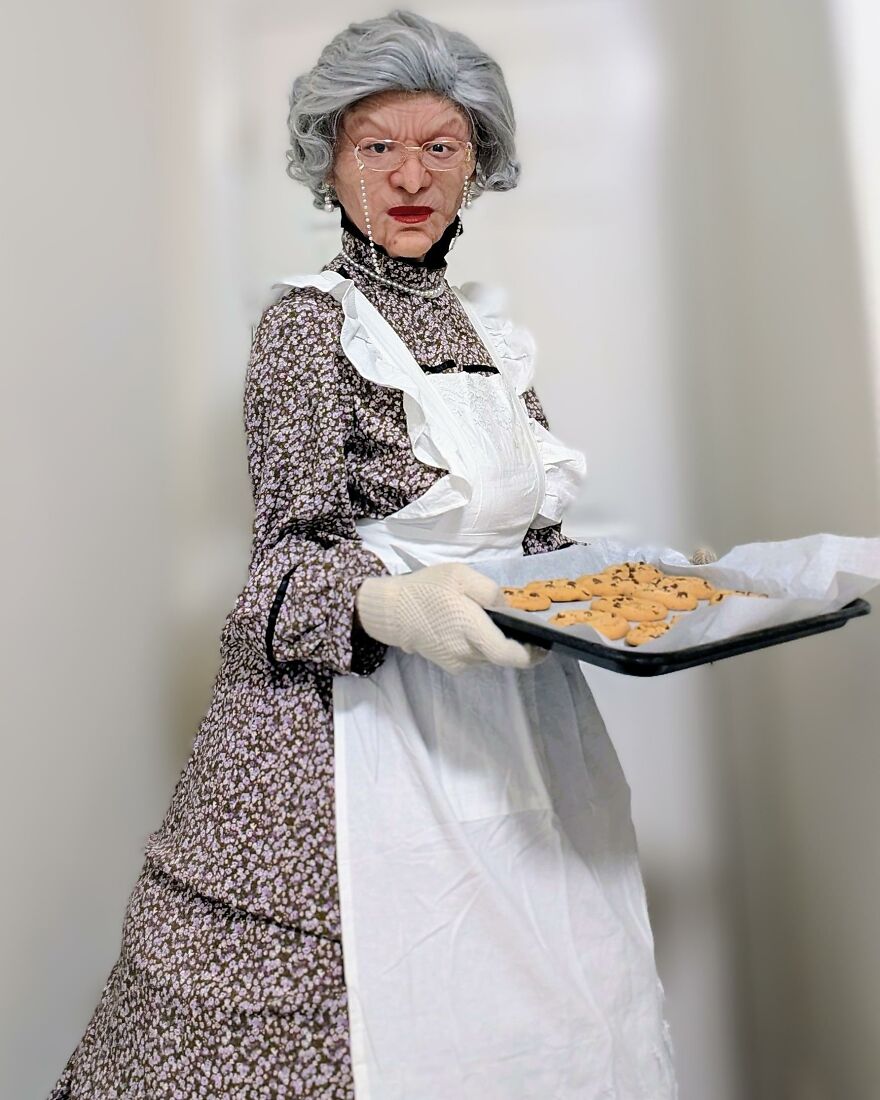 Person dressed in a detailed Mrs Doubtfire grandmother costume holding a tray of cookies for creative Halloween costume ideas.