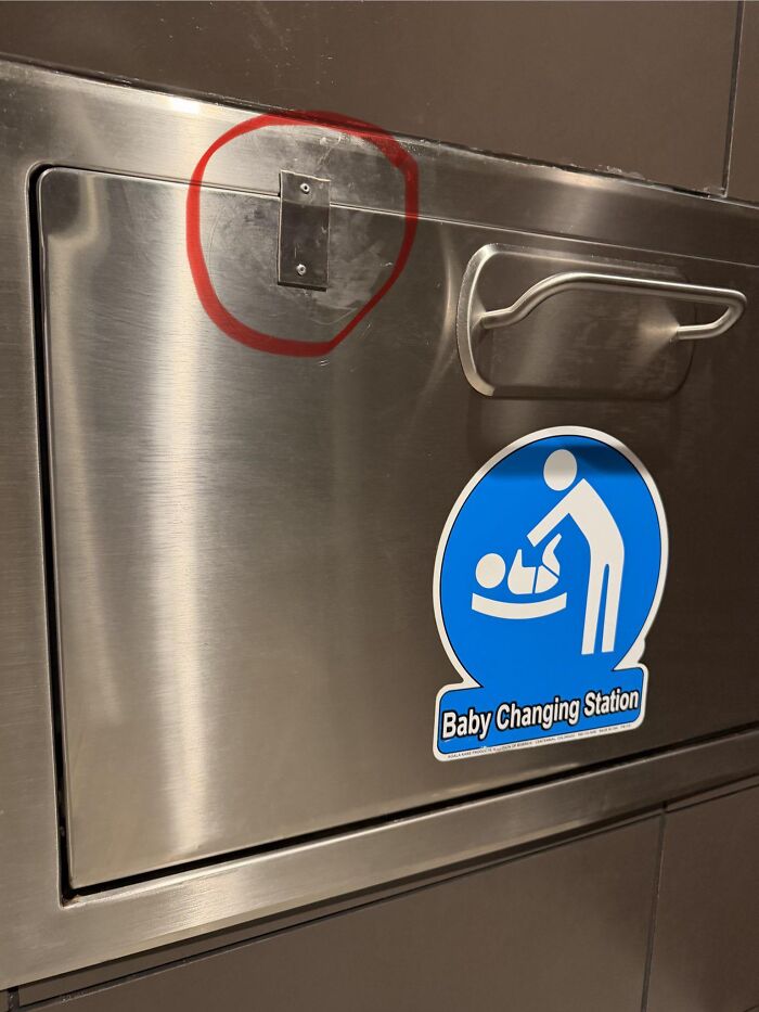 Metal baby changing station with a riveted hinge as one of many absurd products.