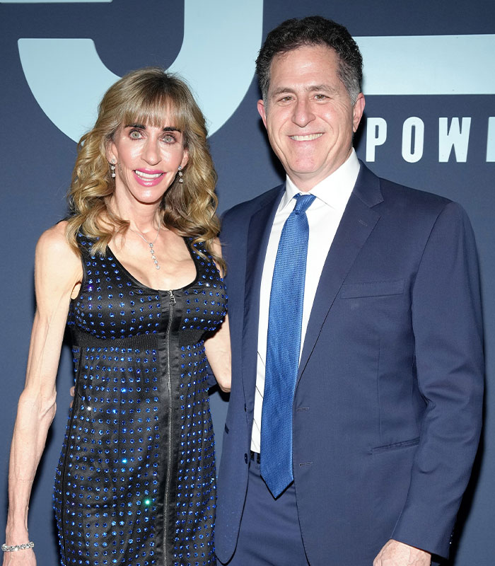 Dell CEO Michael Dell standing alongside his wife Susan Dell at an official public event.
