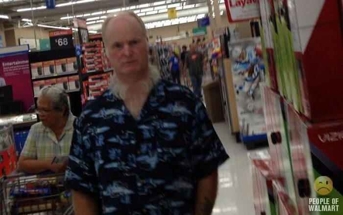 Man in shark print shirt standing in Walmart aisle